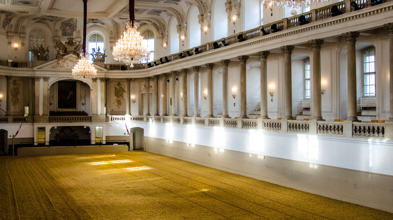 Vienna Spanish Riding School riding hall decorated in baroque columns and crystal chandeliers