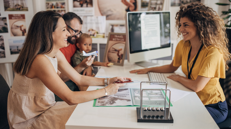 A family working with a travel agent