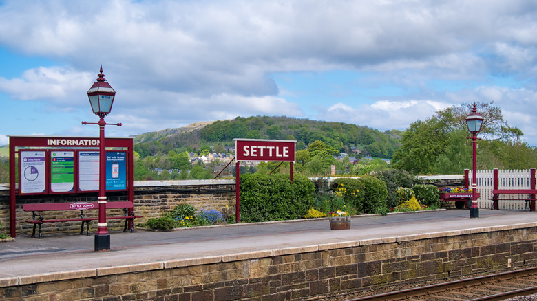 Settle Railway Station in Yorkshire with Sugar Loaf Hill in background