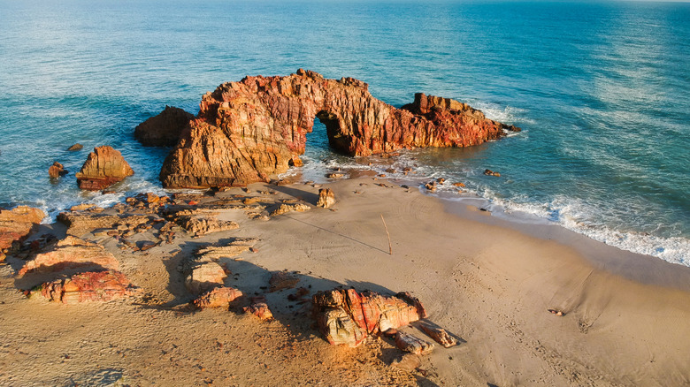 arching rock formation on the beach