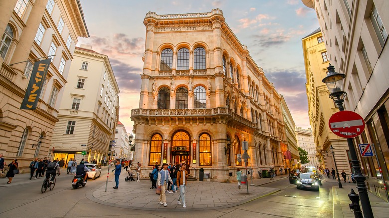 A glowing building housing Cafe Central on a Vienna street corner