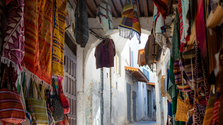 Rugs and blankets hanging in a alleyway in Tangier