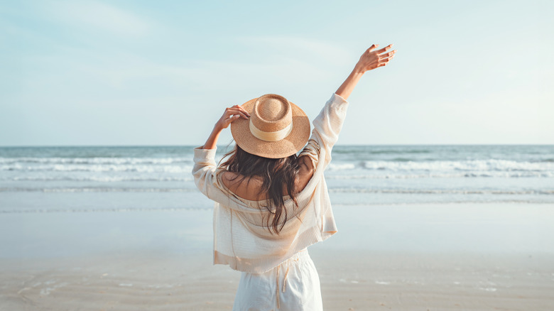 A woman celebrating at the beach