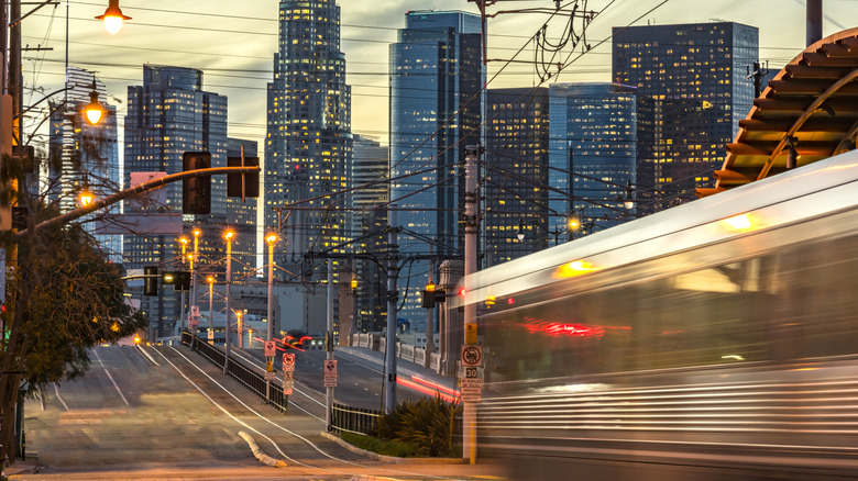 Subway train in motion with LA skyline at dusk