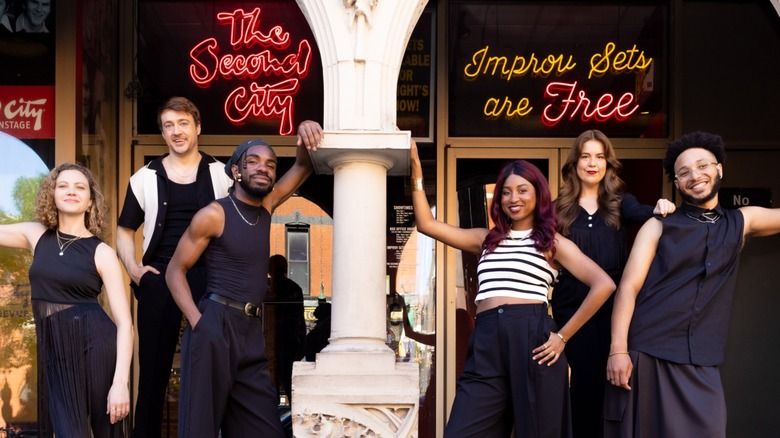 (L-R) Laurel Krabacher, Andy Bolduc, Jordan Stafford, Adisa Williams, Hannah Ingle, and Adonis Holmes in front of The Second City's Chicago Mainstage in Chicago, Illinois