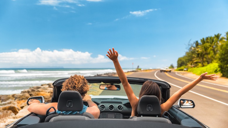 Travelers in a car on a Hawaiian road