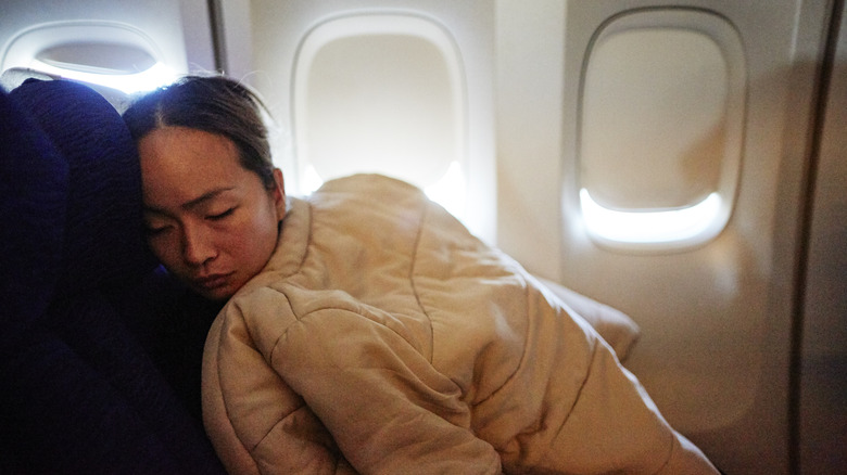 Person bundled up on a cold plane