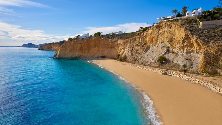 Limestone cliffs at turquoise sea at Playa del Bol Nou