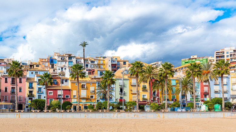 Colorful houses and palm trees at waterfront, Villajoyosa