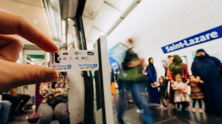 Person holding a Paris metro ticket