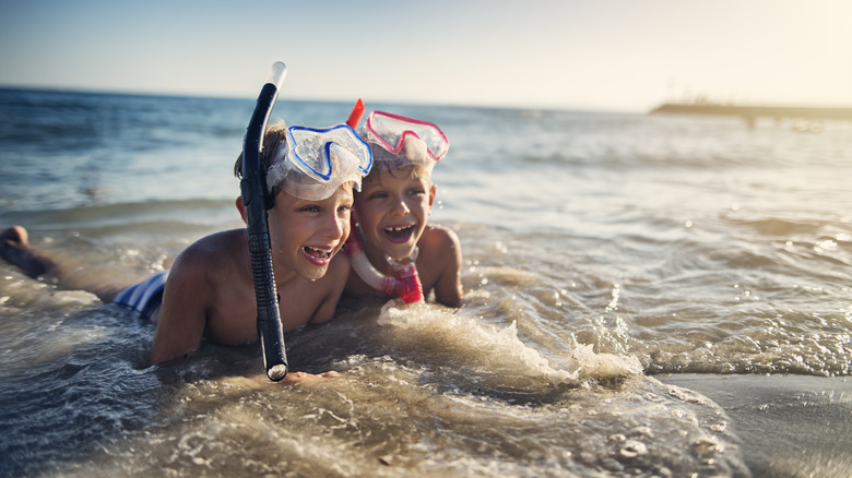 Kids with their snorkeling gear on a shore