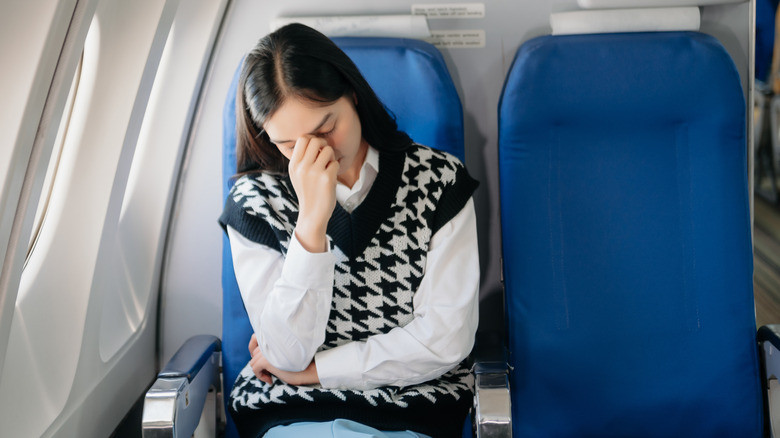 Woman annoyed on an airplane.