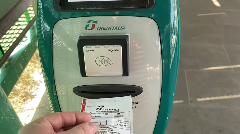 Validating a ticket at a Trenitalia machine