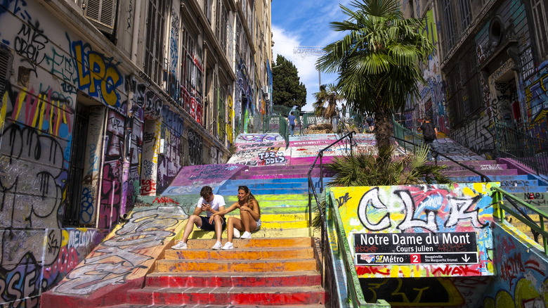 Young couple sitting on staircase Cours Julien