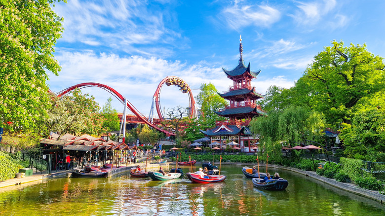 Rollercoasters and boats at Tivoli Gardens theme park in Copenhagen, Denmark