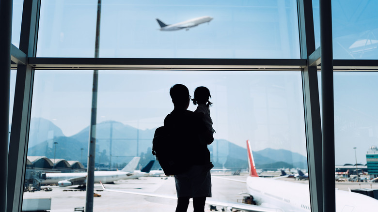 A father and daughter in an airport