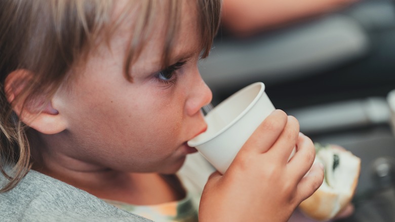 Boy drinking from paper cup