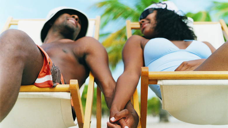 Couple holding hands on beach