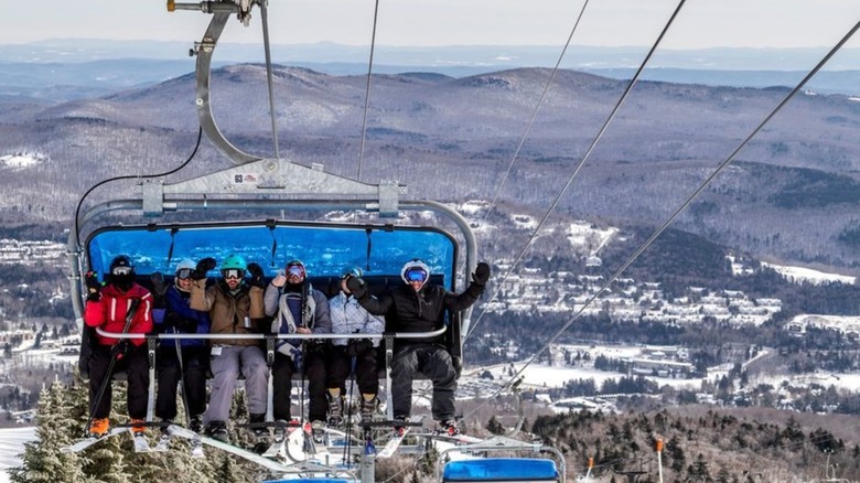 Skiers pose on the chair lift in Mount Snow, Vermont