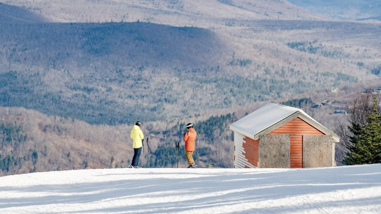 Skiers look out at views from Sunday River, Maine