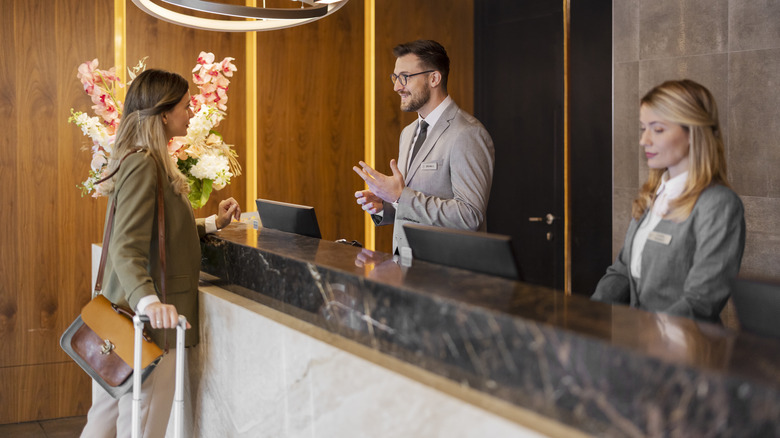 Traveler talking to hotel concierge