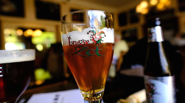 Glass of Brugse Zot with jester character