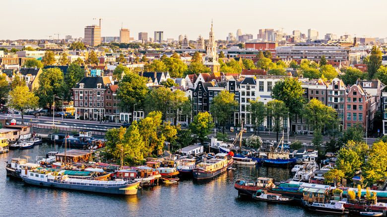 Amsterdam cityscape with canal boats in foreground