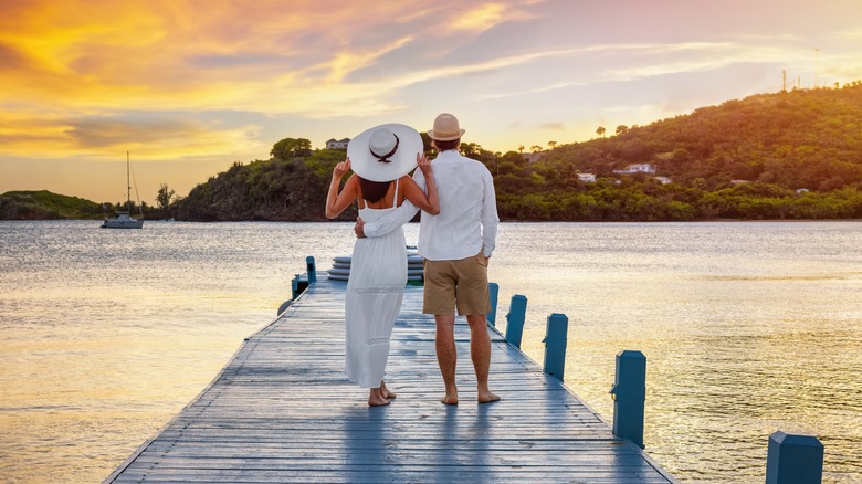 Couple enjoys the sunset from a pier on a Caribbean island