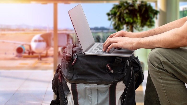 Person using computer in airport 