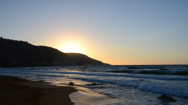 Ramla Bay's red sand beach at sunset