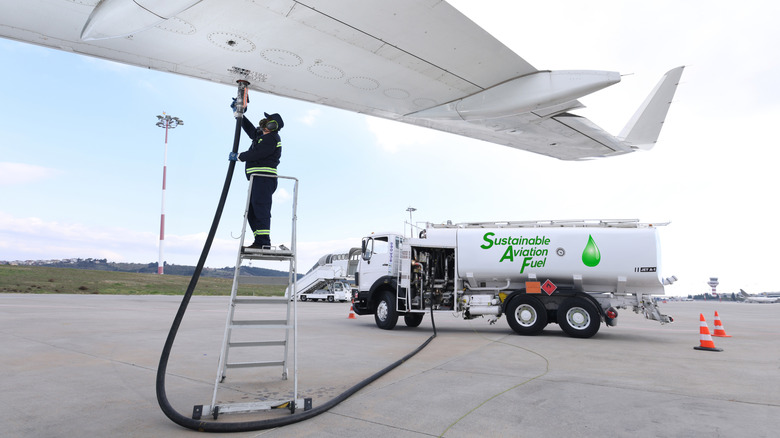 Technician refuelling an aircraft with sustainable aviation fuel