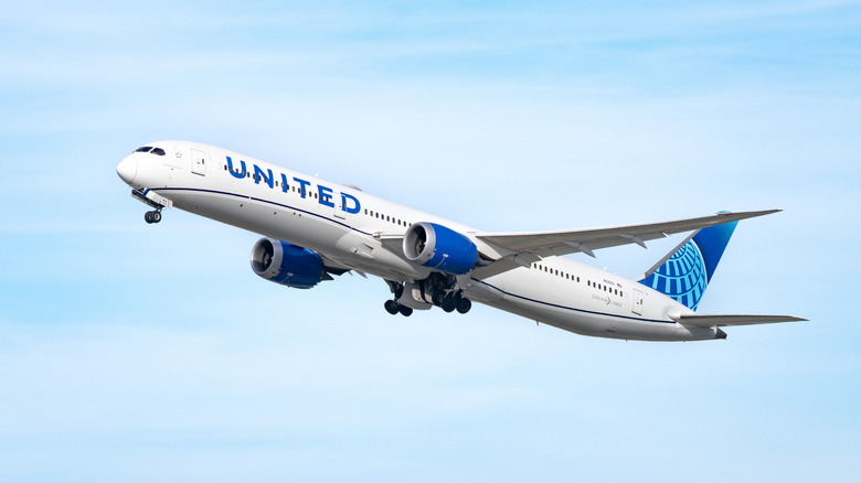 A United Airlines plane soaring through the sky