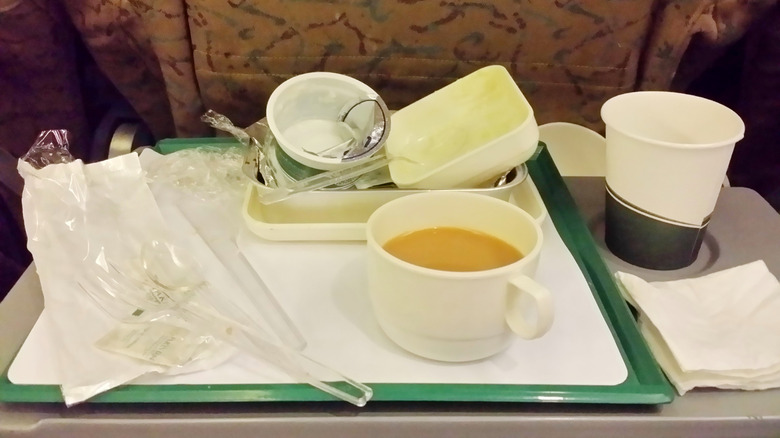 Garbage on the middle tray on a plane