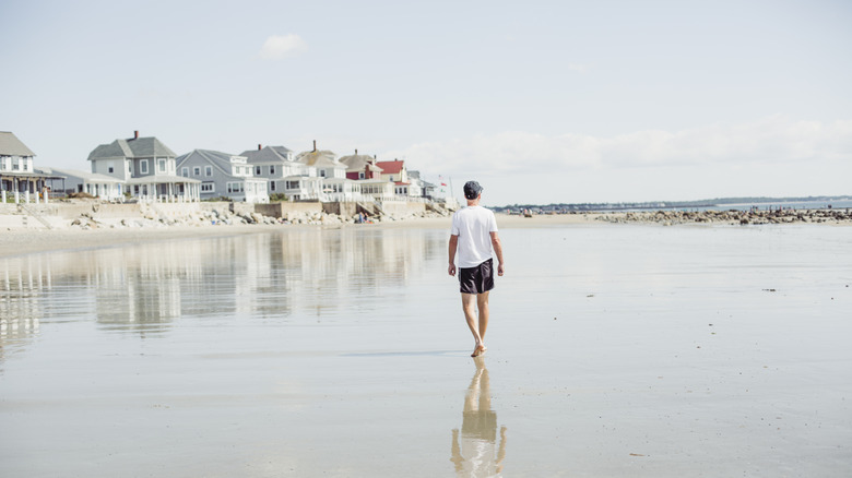 A person walking on the beach in Wells, Maine