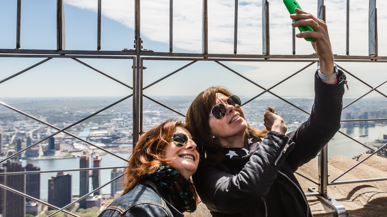 Two women posing for a selfie on the Empire State Building Observation Deck