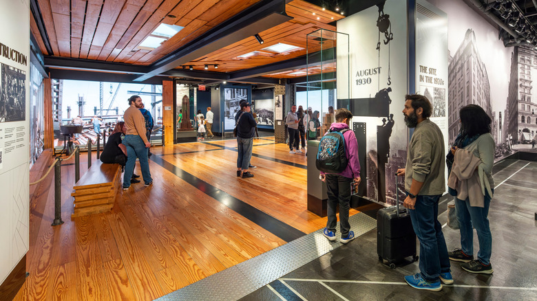 The interior of the Empire State Building with guests looking around