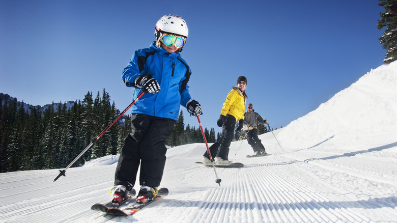 skiers skiing down mountain