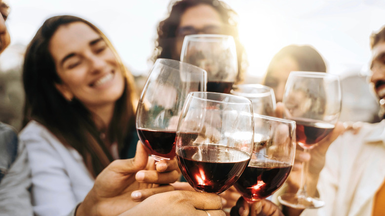 Friends clinking wine glasses