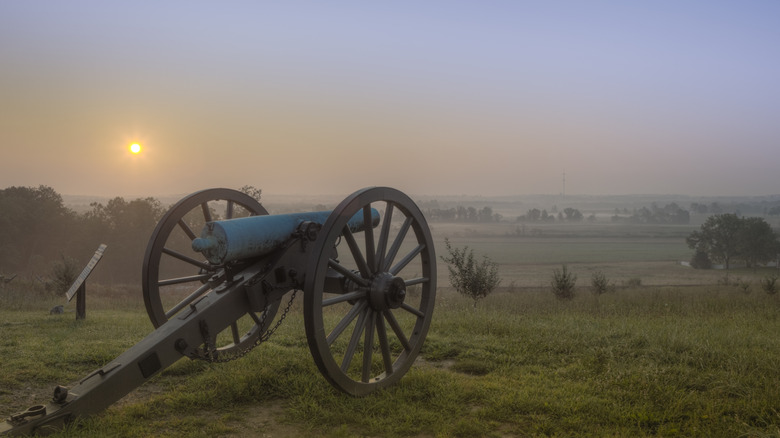 Civil war cannon over a misty field