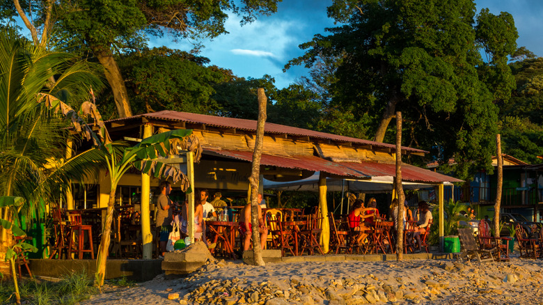 Beach bar with palm trees at Playa Maderas