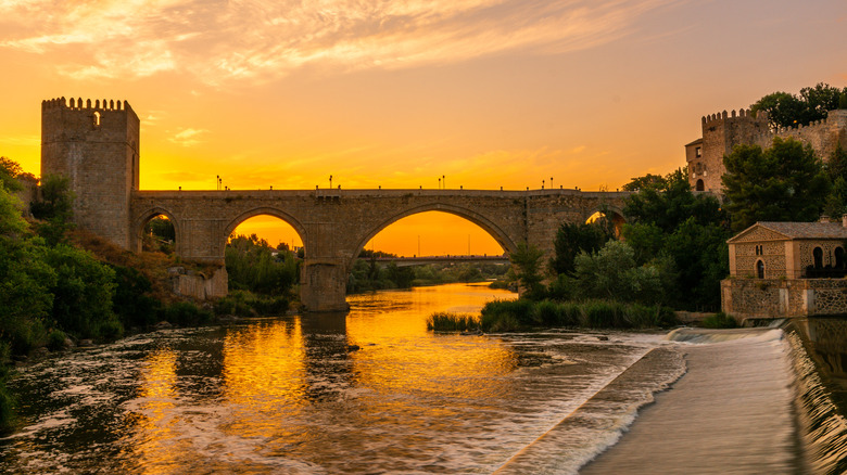 Sunset behind St Martin Bridge in Toledo, Spain