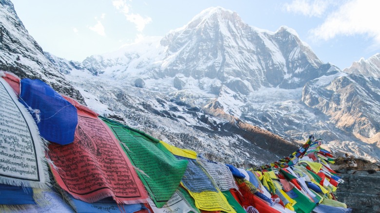 Prayer flags blowing in the wind in the Himalayas, as seen from Annapurna Base Camp in Nepal