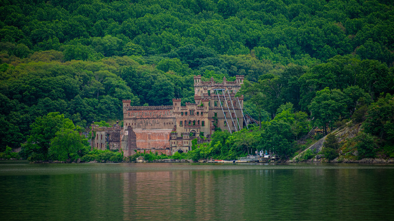 Bannerman Castle on the Hudson River, surrounded by lush forest