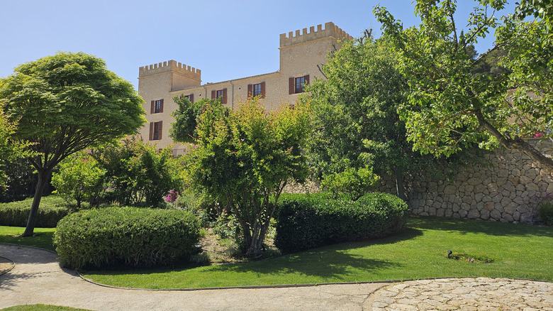 The turrets of Castell Son Claret peak above the foliage of the hotel's gardens