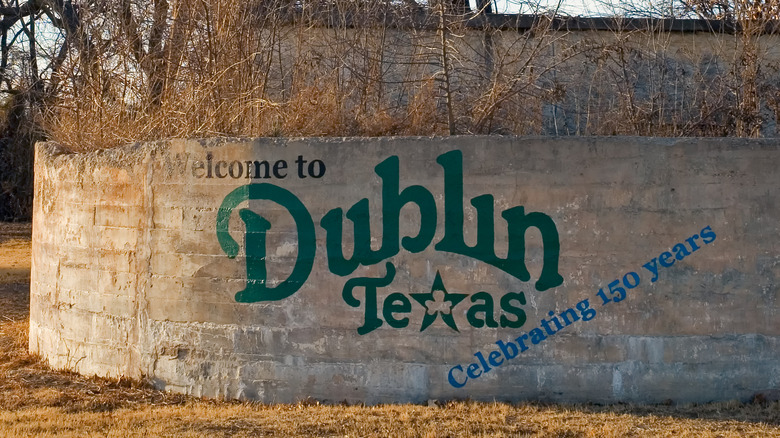 A concrete wall with "Welcome to Dublin, Texas" printed on the side