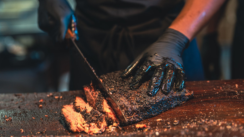 BBQ chef prepares a smoked brisket