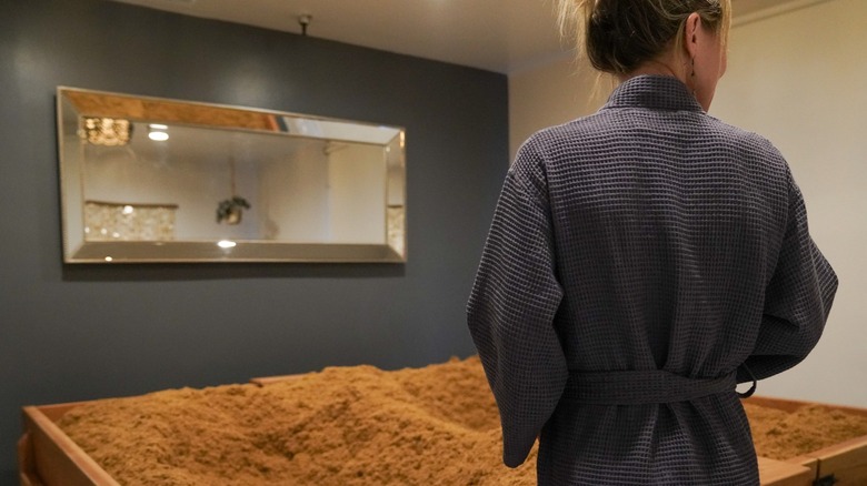 A woman about to get into a cedar enzyme bath at Tahoe Forest Baths in Nevada