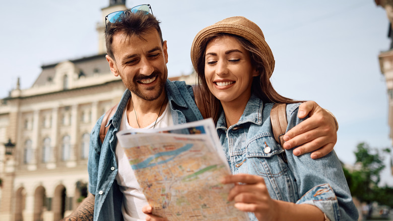 Traveling couple looking at a map