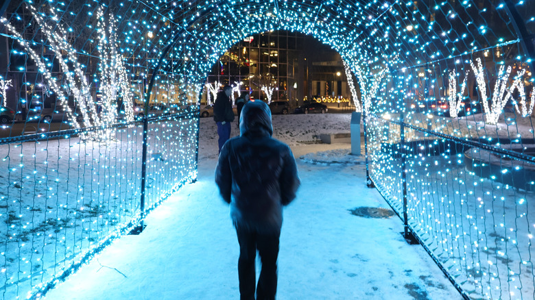 Person walking through Christmas lights at night in Grand Rapids, Michigan