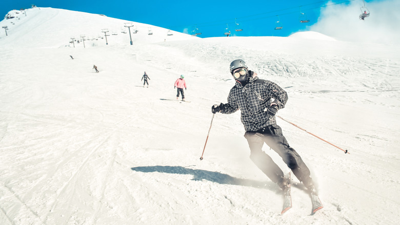 Skiing in a line down a mountain